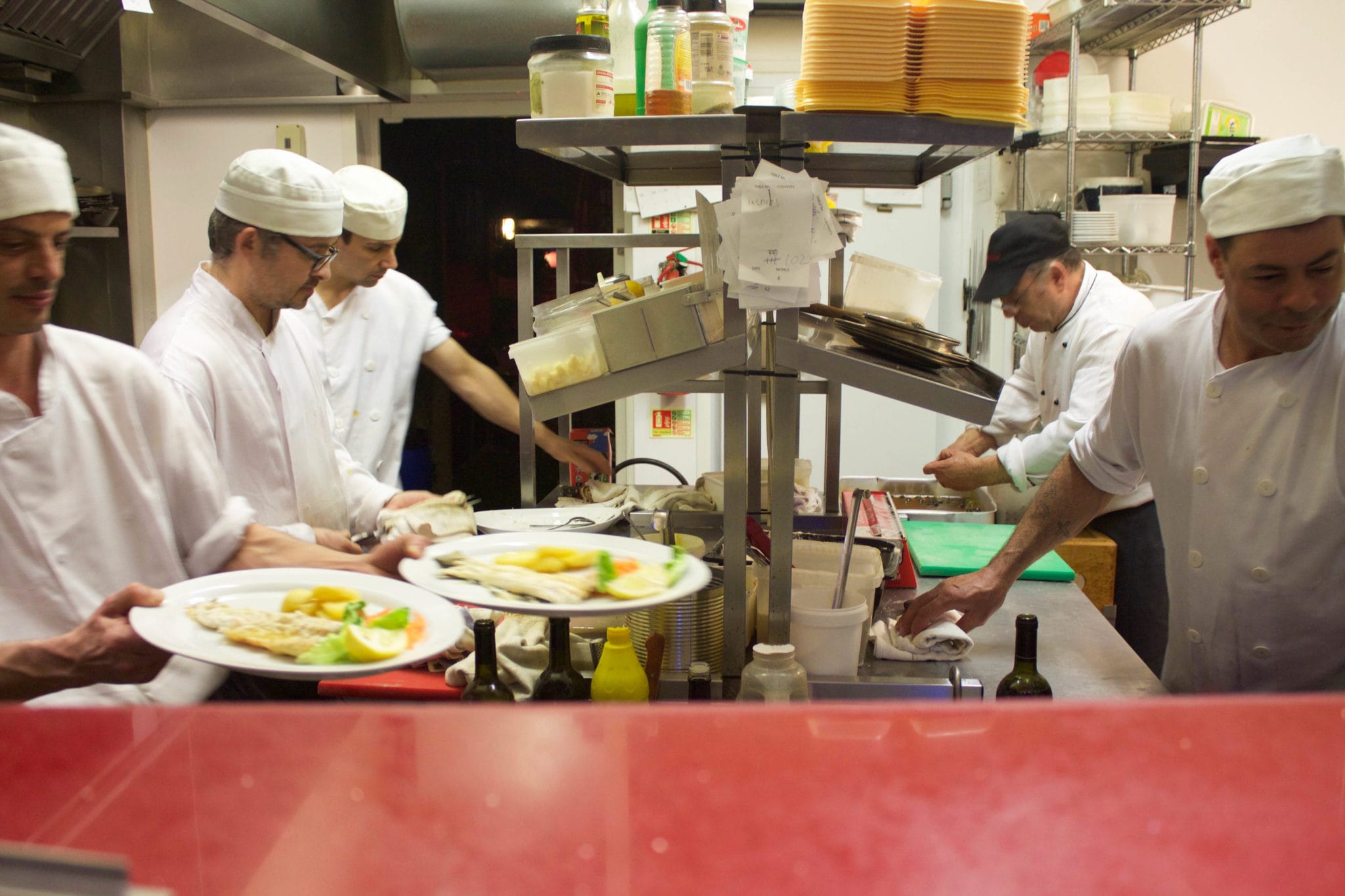 Chefs preparing food in kitchen