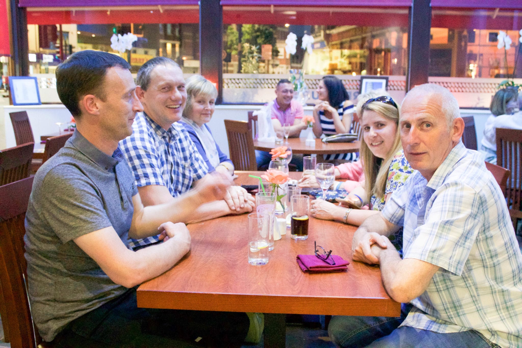 smiling customers sitting at a table